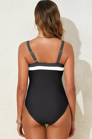 82% polyamide, 18% elastane Care instructions: Machine wash cold one-piece swimsuit in black with fitted silhouette