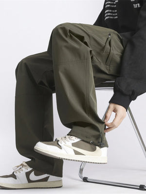 Relaxed fit green cargo pants with zip pockets and adjustable ankle cuffs.