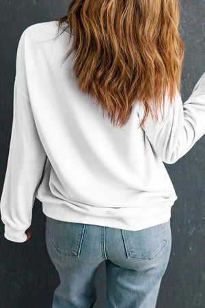 White round neck sweatshirt with long sleeves and a relaxed fit, styled with jeans.