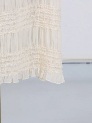 Textured cream halter neck maxi maternity swim dress with tiered ruffles.