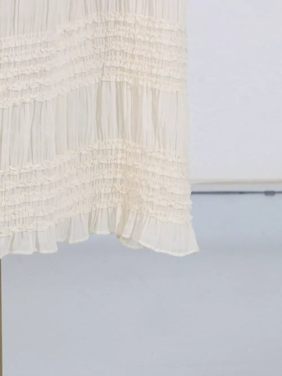 Textured cream halter neck maxi maternity swim dress with tiered ruffles.