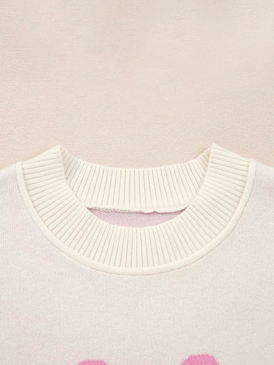 Beige acrylic blend sweater with drop shoulders and a bow print, featuring a ribbed neckline detail.