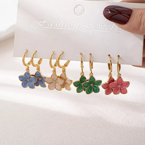 earrings in gold featuring flower charm and drop fit
