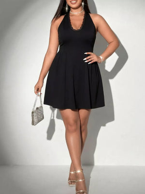 Black lace-trimmed halter A-line dress with a pleated skirt.