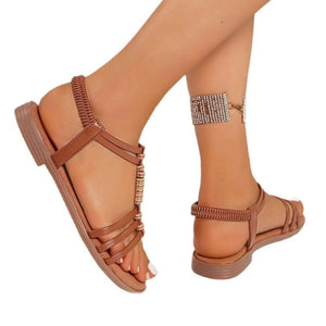 Brown strappy flat sandals with elastic back and beaded detail.