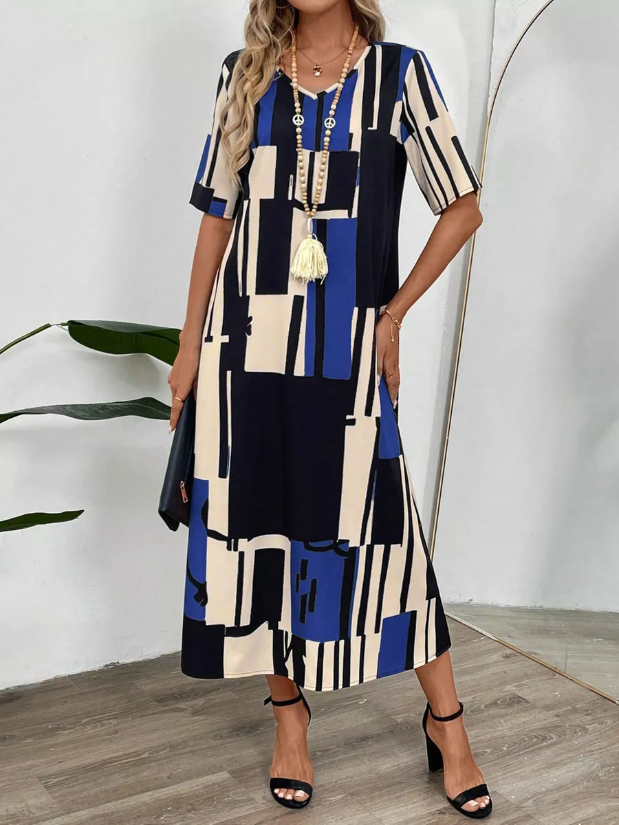 Geometric V-neck midi dress in dark blue with abstract block print, short sleeves, and a relaxed fit.