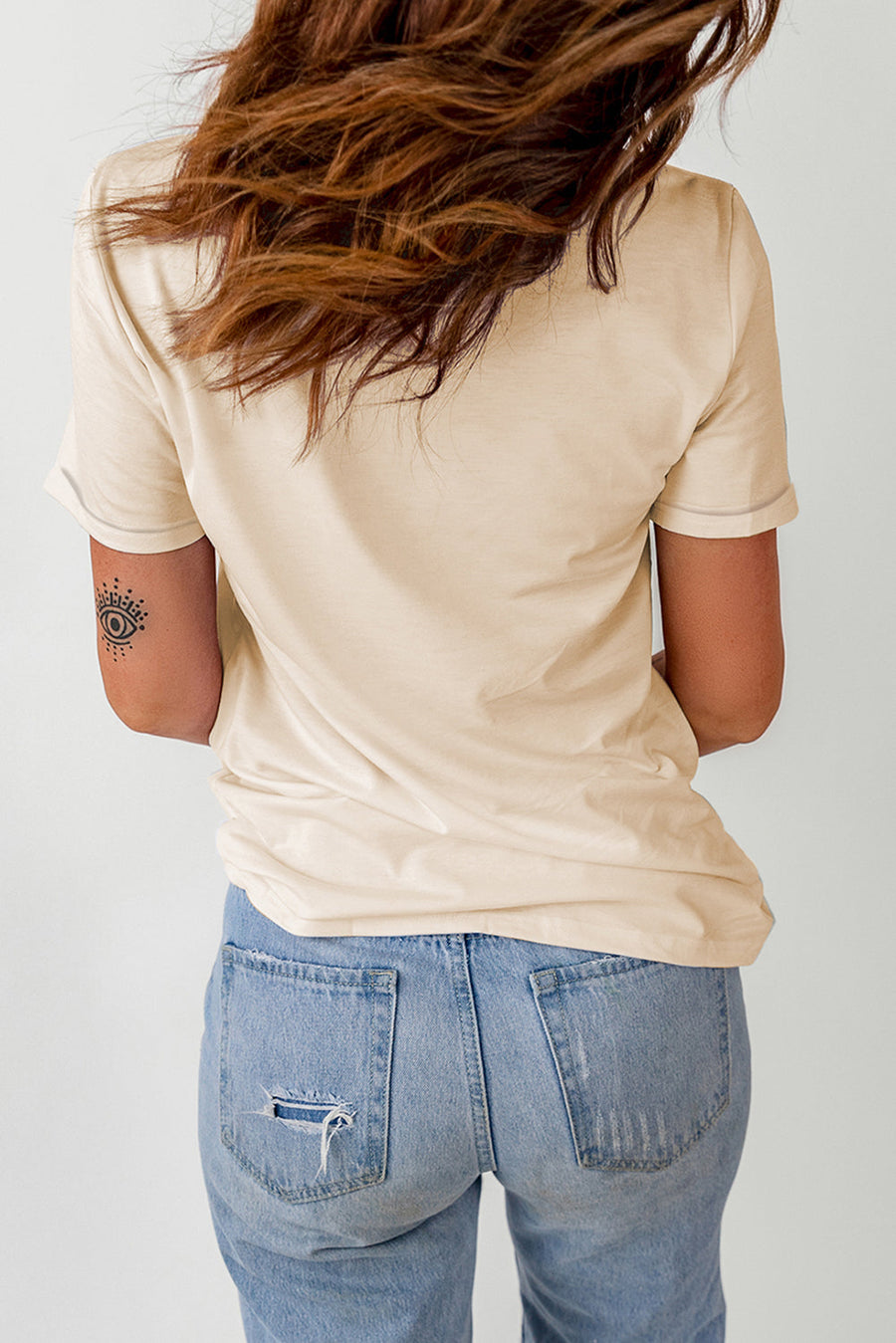 Light Apricot basic t-shirt with short sleeves and a crew neck, styled with distressed denim jeans.