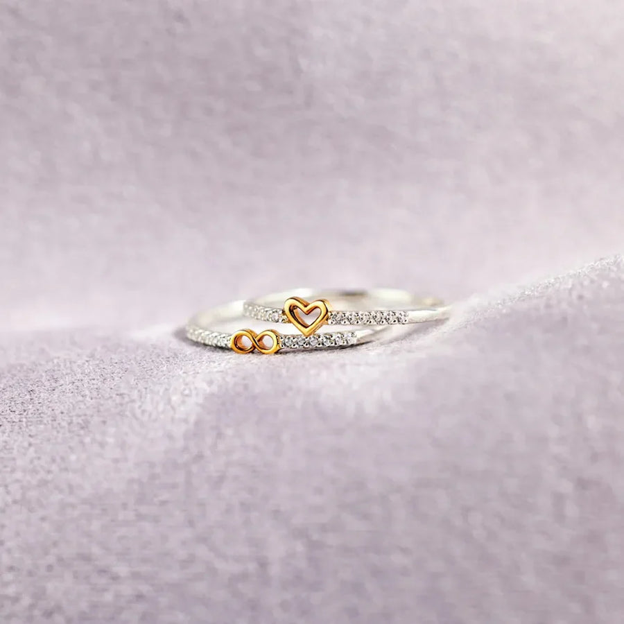 Silver rings with heart and infinity charms, accented with small crystals
