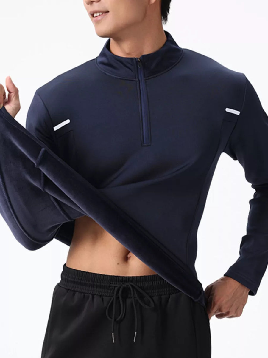 Men's dark navy cotton half-zip sweatshirt with a stand-up collar and subtle reflective accents.
