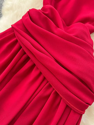 Red maternity maxi dress with draped floral accent detail.