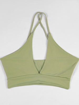 At least 95% polyester with spandex halter top in sage green with fitted silhouette