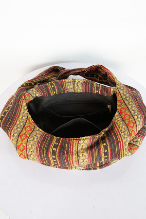 Tribal weave shoulder bag with multicolor pattern and zippered interior.