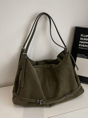 handbag in olive green featuring adjustable straps and slouchy fit