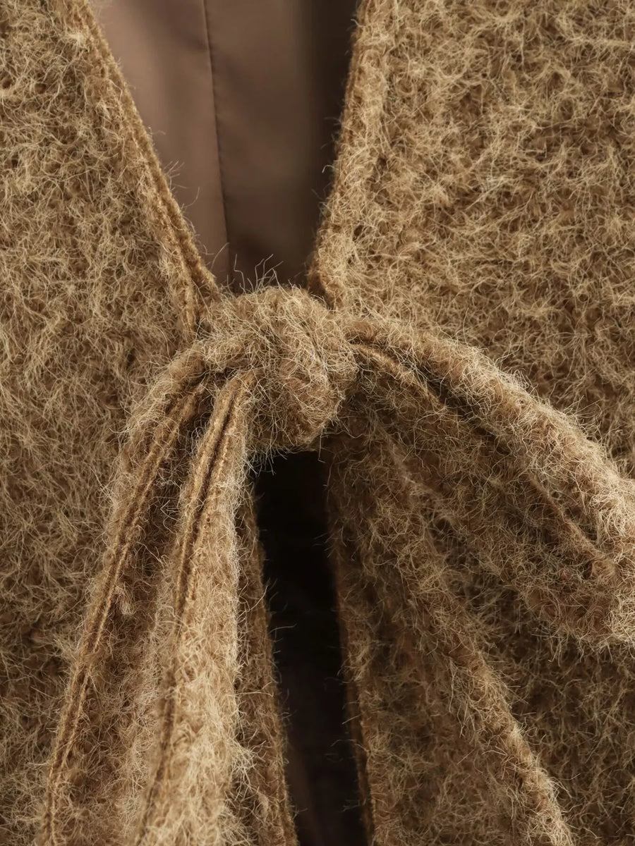 Textured knit tie-front cardigan in dark brown with a fuzzy, open weave and a knot detail.