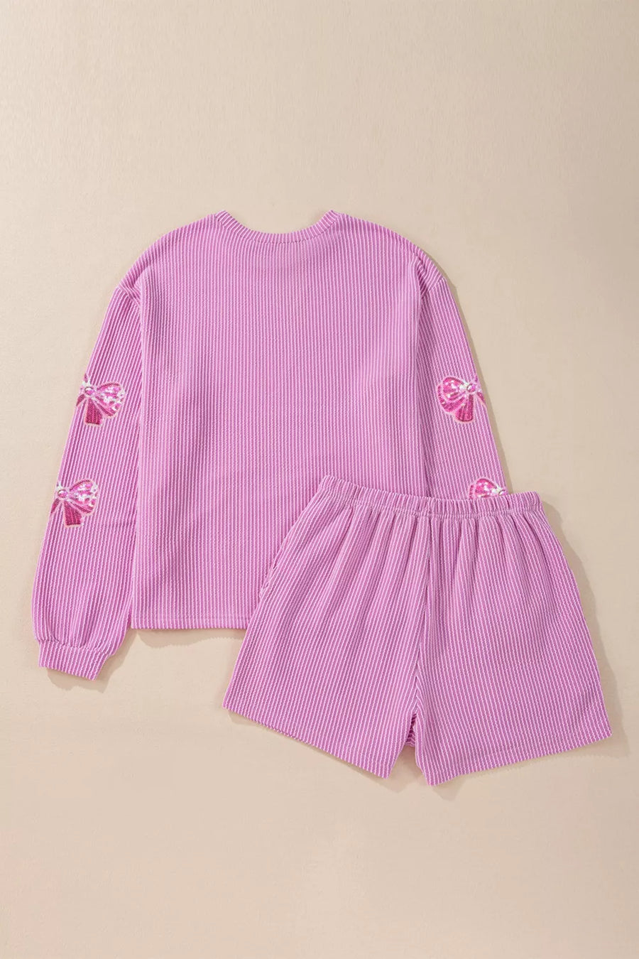 Purple seersucker two-piece outfit set with sequin bow details on sleeves.