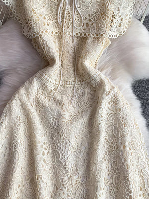 Cream floral lace A-line dress with tie detail and cutout neckline.