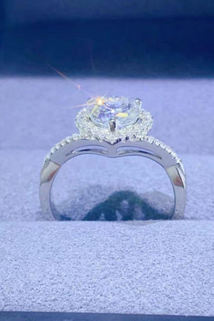 Silver engagement ring with a heart halo moissanite center stone and diamond band.