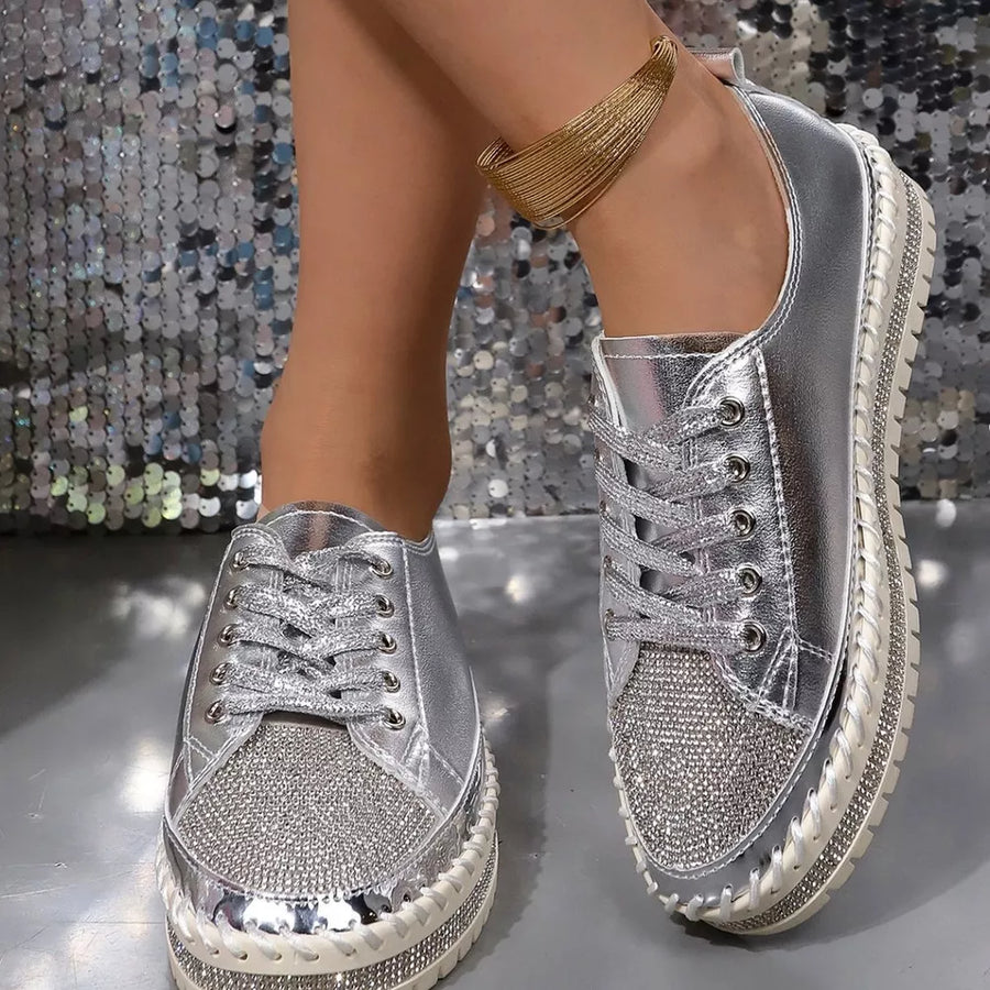 Silver rhinestone toe sneakers with chunky sole and lace-up closure.