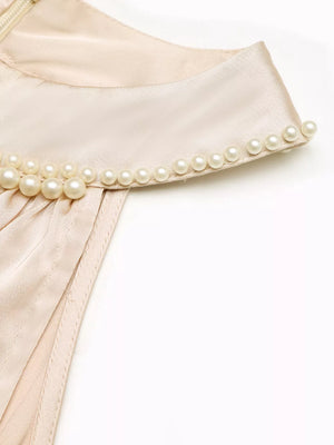 Champagne satin midi dress with pearl-embellished neckline detail.