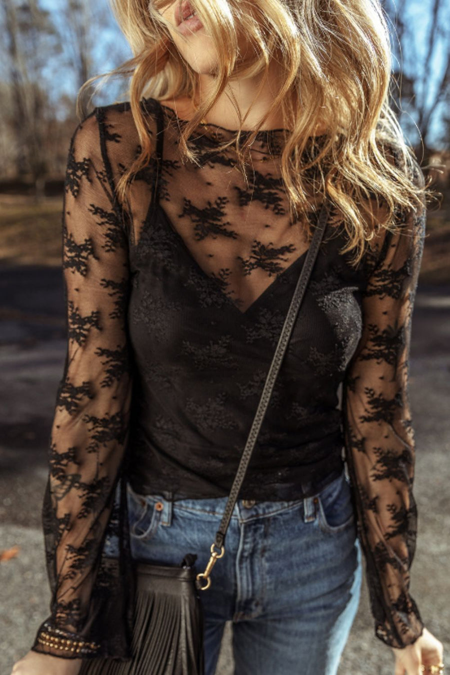 Black floral lace bodysuit with long sleeves and a V-neck cami underneath.