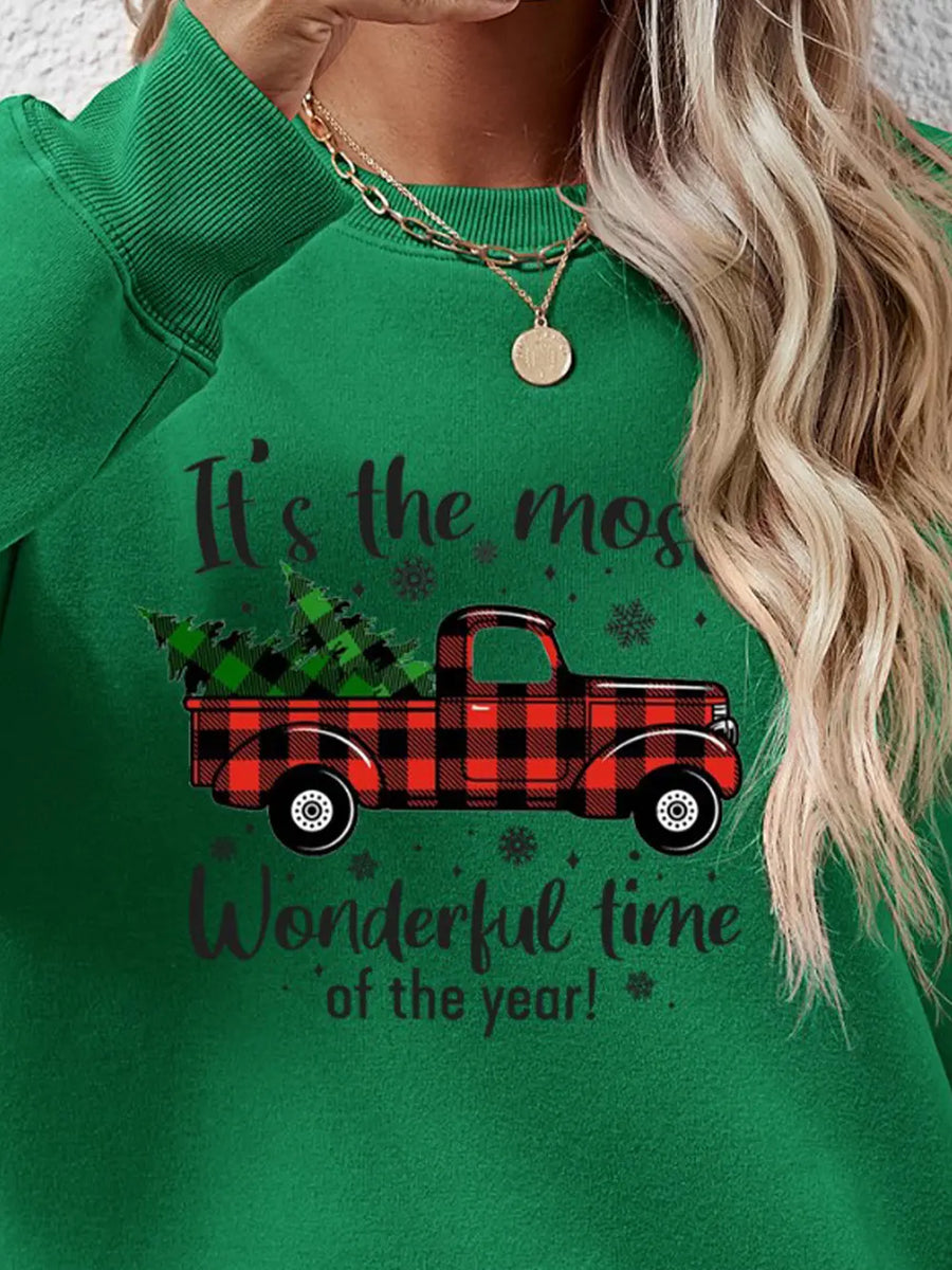 Green sweatshirt with buffalo plaid truck and Christmas tree graphic.
