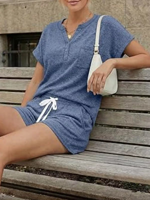 Relaxed blue two-piece set with pocketed henley top and drawstring shorts