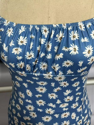 Sky blue spaghetti strap midi dress with white daisy print and ruched bodice.