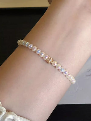 gold bracelet featuring pearls and floral