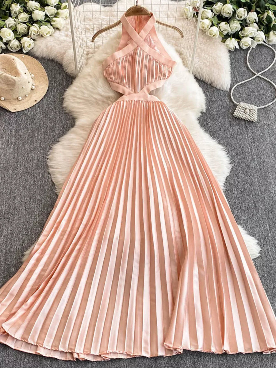 Peach pleated maxi dress with cutout details and halter neckline.
