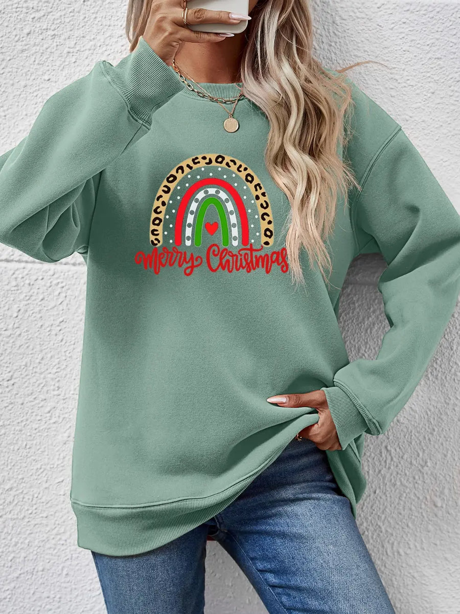 Sage green sweatshirt with rainbow Christmas graphic and leopard print detail.