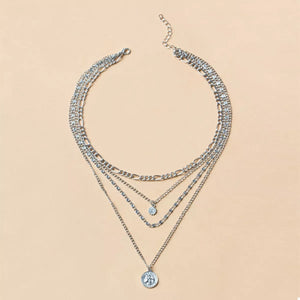 Silver layered necklace with coin pendant and crystal charm