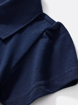 Navy blue pique knit polo shirt with short sleeves and a classic collar.