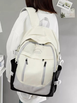 Chic color block nylon backpack in cream, gray, and black with adjustable straps and multiple zippered pockets.