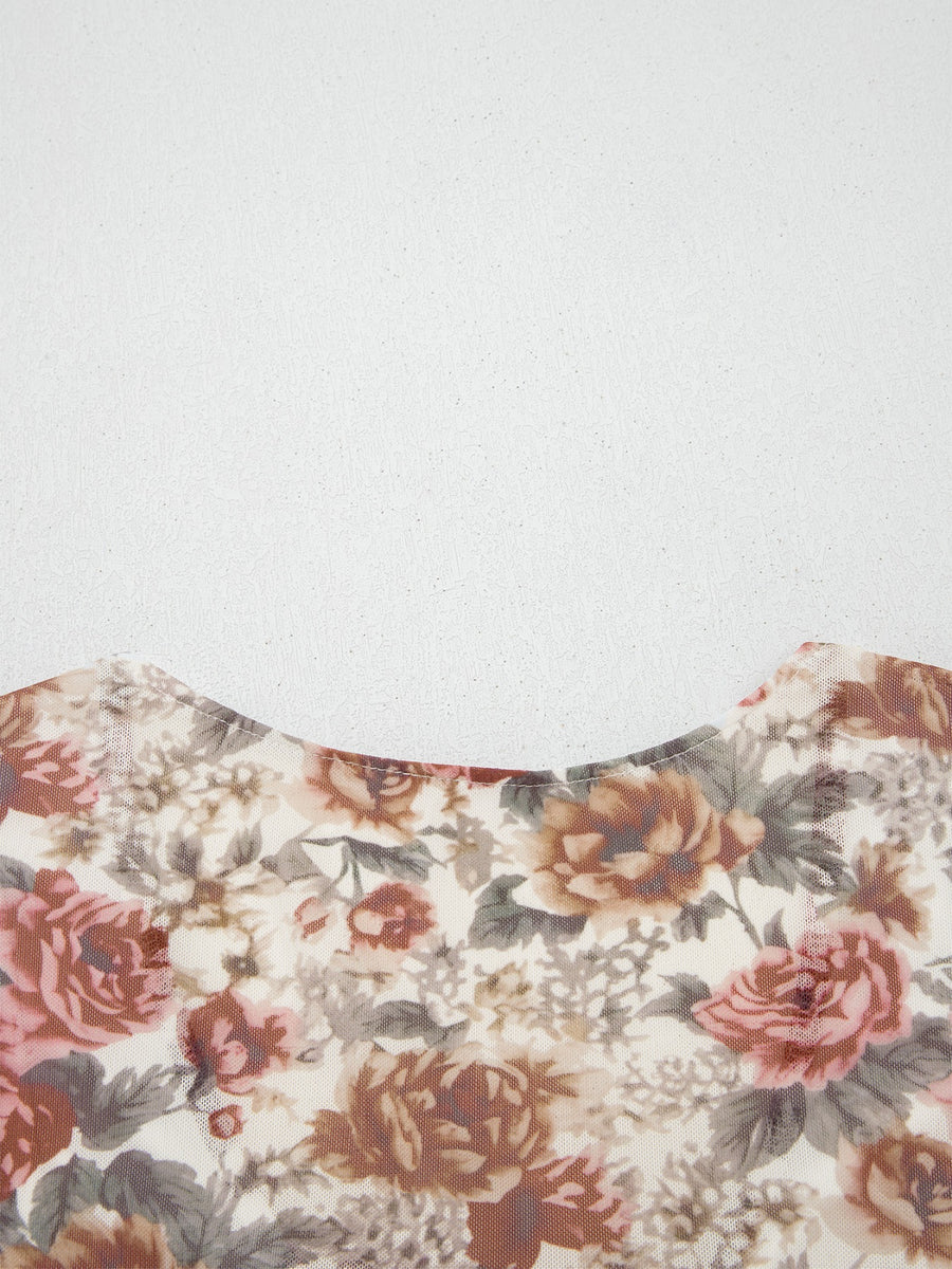 Charming floral mesh blouse with a round neckline and ruffled detail.