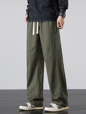 wide-leg pants in olive green featuring drawstring waist and loose fit