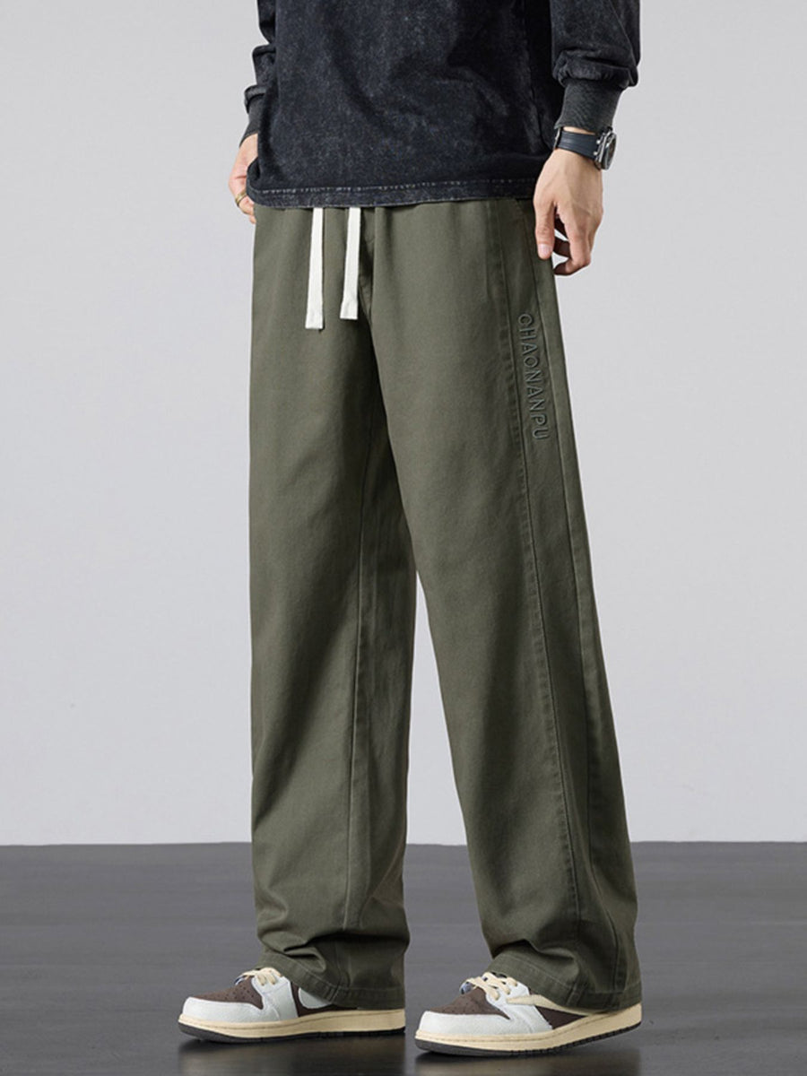 wide-leg pants in olive green featuring drawstring waist and loose fit