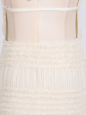Cream textured halter neck maxi maternity swim dress with smocked waist and tiered skirt detail.