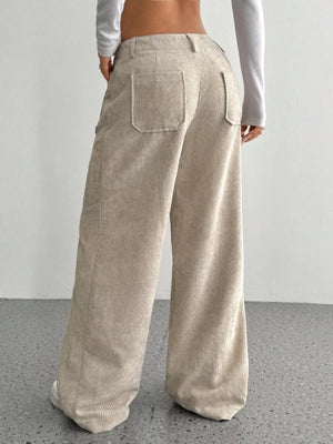 Chic wide-leg corduroy trousers in apricot with back pockets and a relaxed fit.
