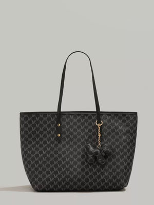 Black monogram tote bag with dog charm and gold hardware