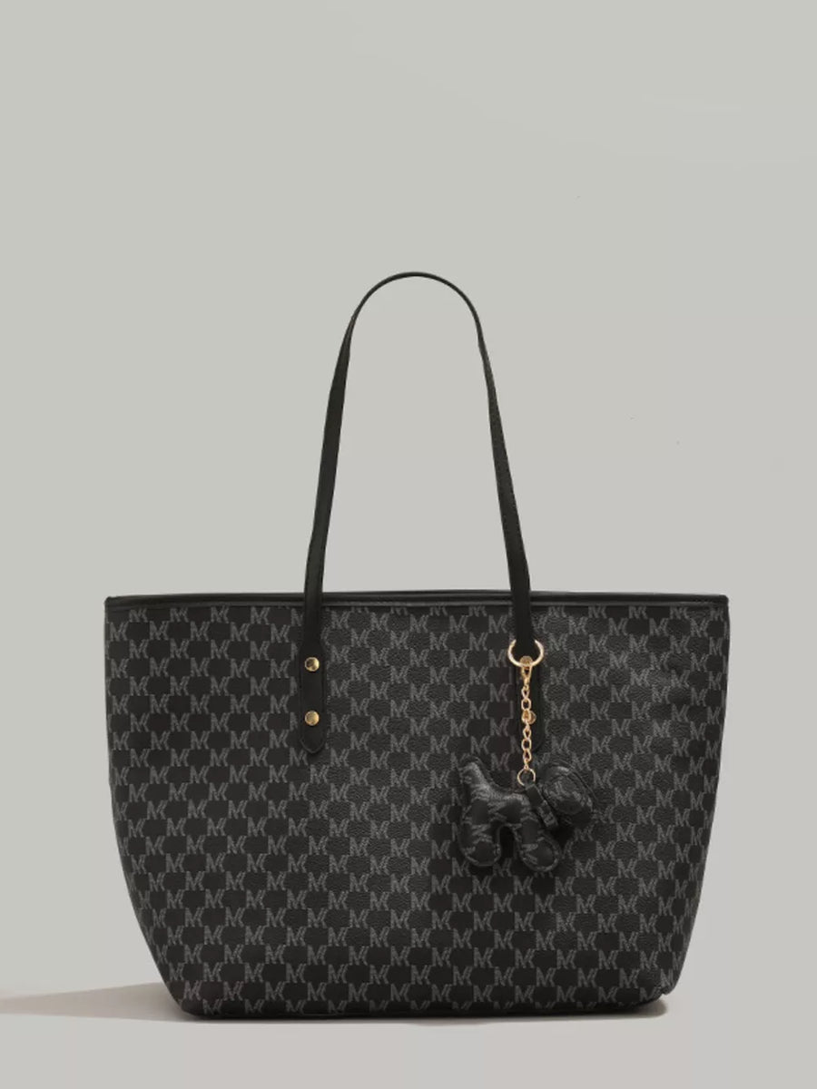 Black monogram tote bag with dog charm and gold hardware