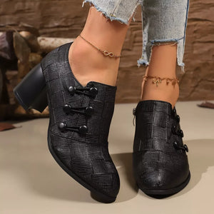 Black woven button-detail high heels with a textured pattern and block heel.
