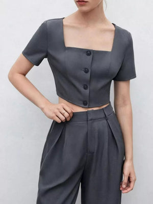 Chic square neck two-piece set in charcoal grey with buttoned crop top and pleated wide-leg pants.