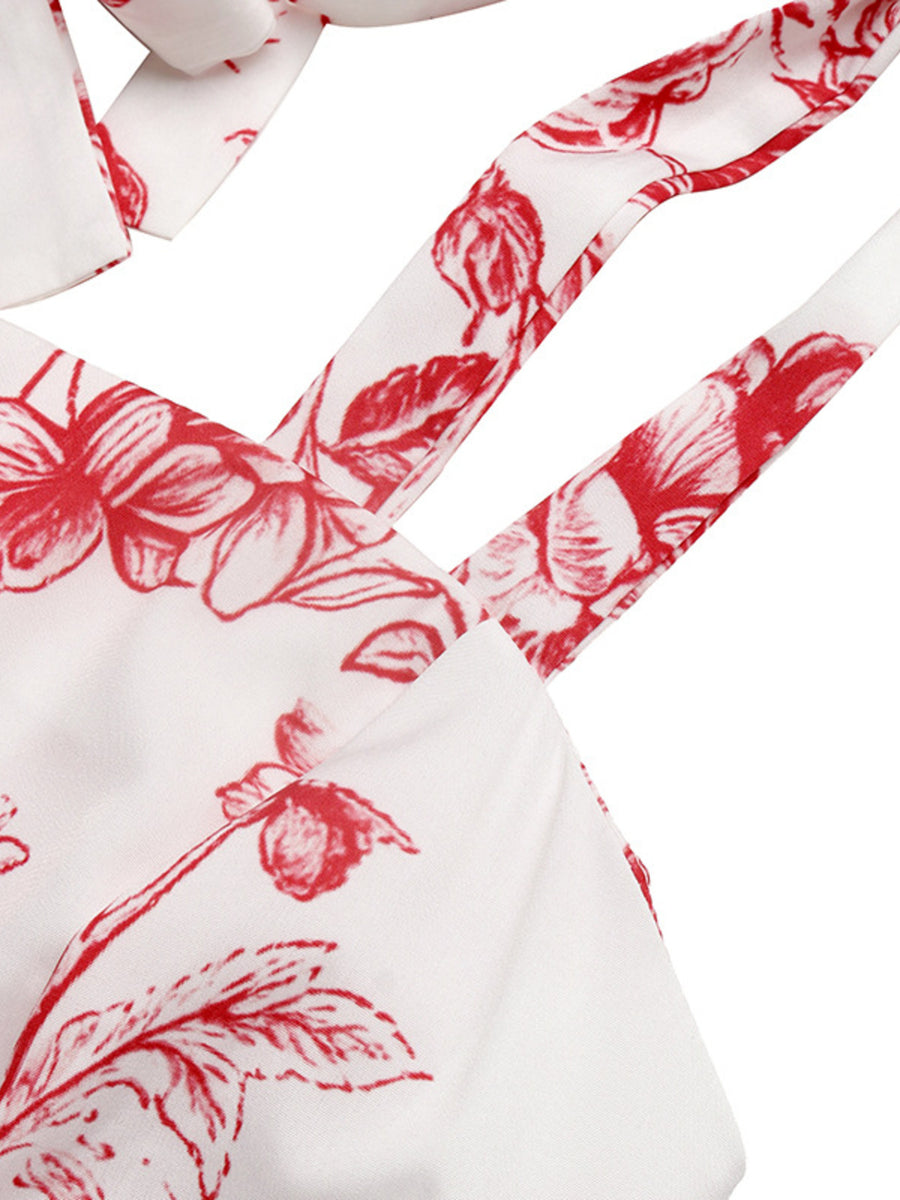 White maxi dress with red floral print and tie straps.