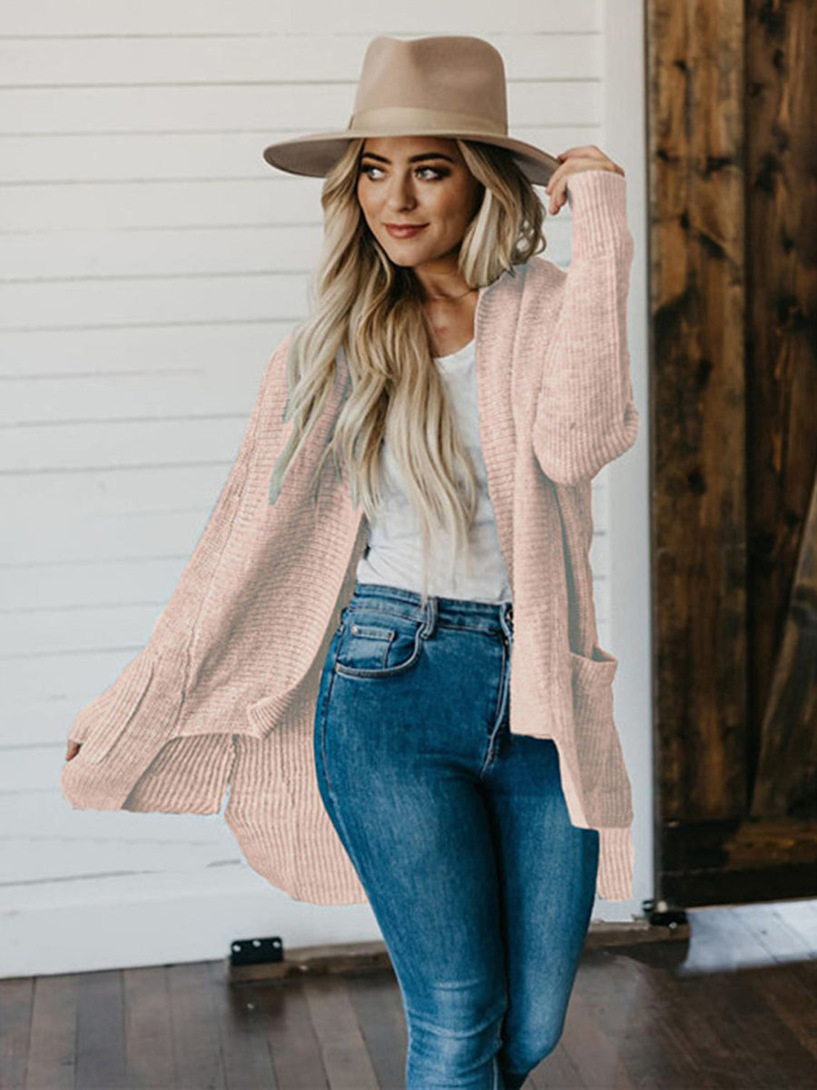 Apricot ribbed knit cardigan with drape front and pockets, worn by a model.