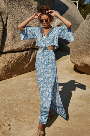 Light blue floral crop top with tie front and wide sleeves, paired with a maxi skirt with side slit.