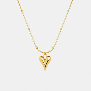 Gold necklace with beaded chain and sculpted heart pendant