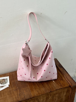 handbag in light pink featuring shoulder strap and loose fit