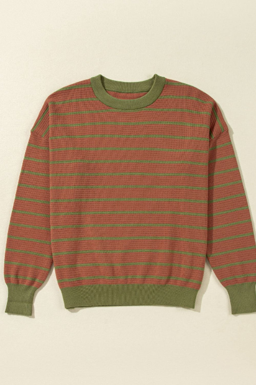 Waffle knit sweater with green stripes and olive green trim.