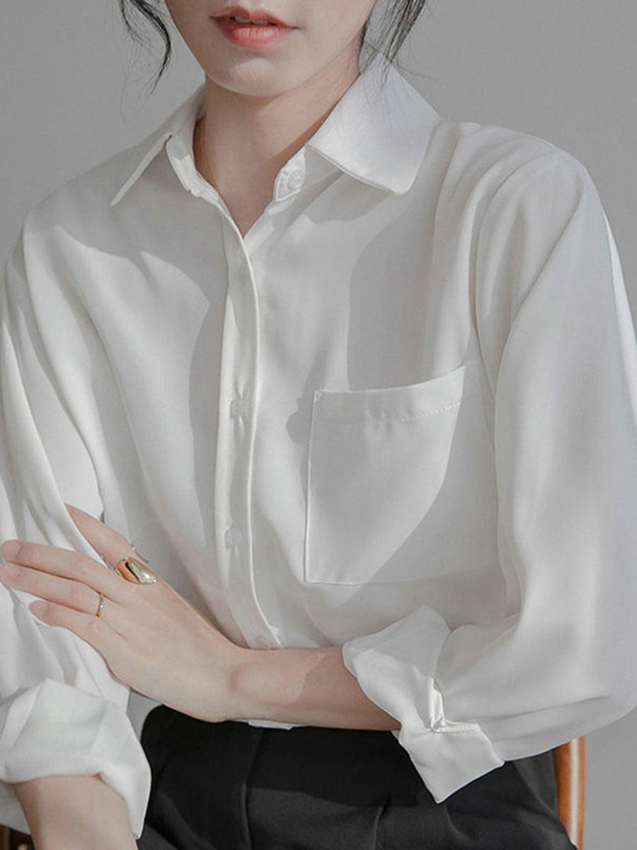 button-up shirt in white featuring pocketed and relaxed fit