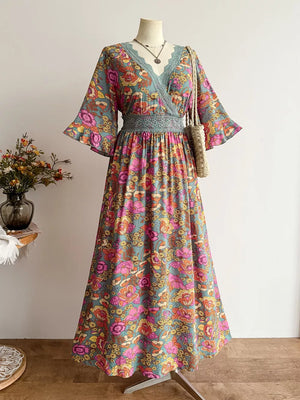 Floral lace-trimmed surplice maxi dress in deep rose with a bohemian floral print and wide sleeves.